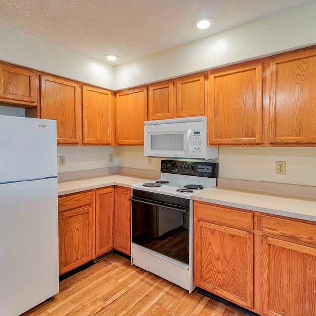 Walnut Springs -  Modern style kitchen equipped with refrigerator, microwave, cooking tools, etc