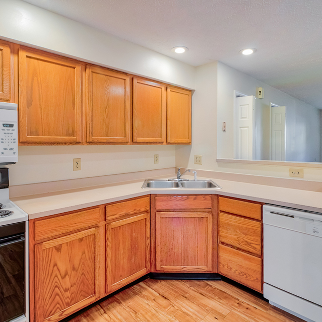 Walnut Springs -  Modern style kitchen equipped with refrigerator, microwave, cooking tools, etc